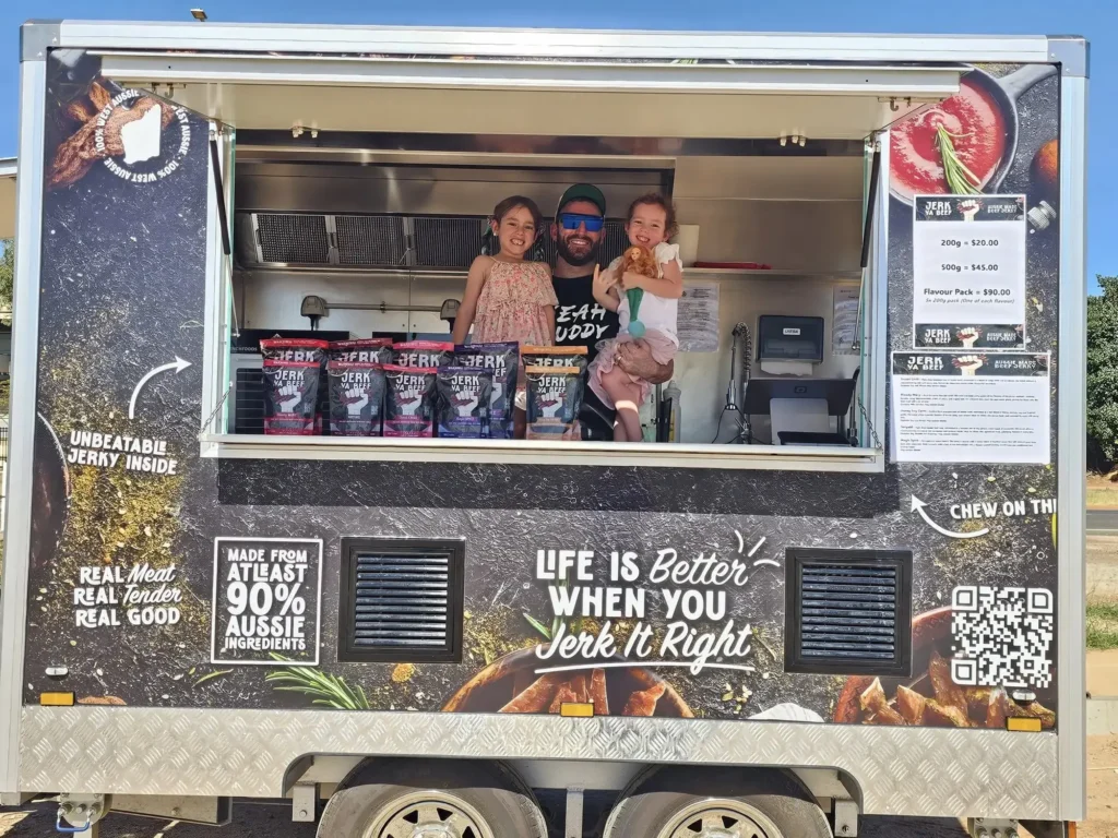 Jerk Ya Beef beef jerky trailer setup with Owner Chris and his kids